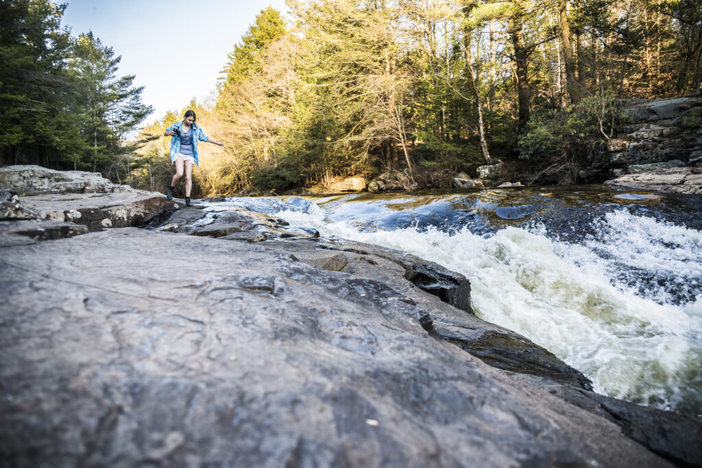 Girl walking along stream